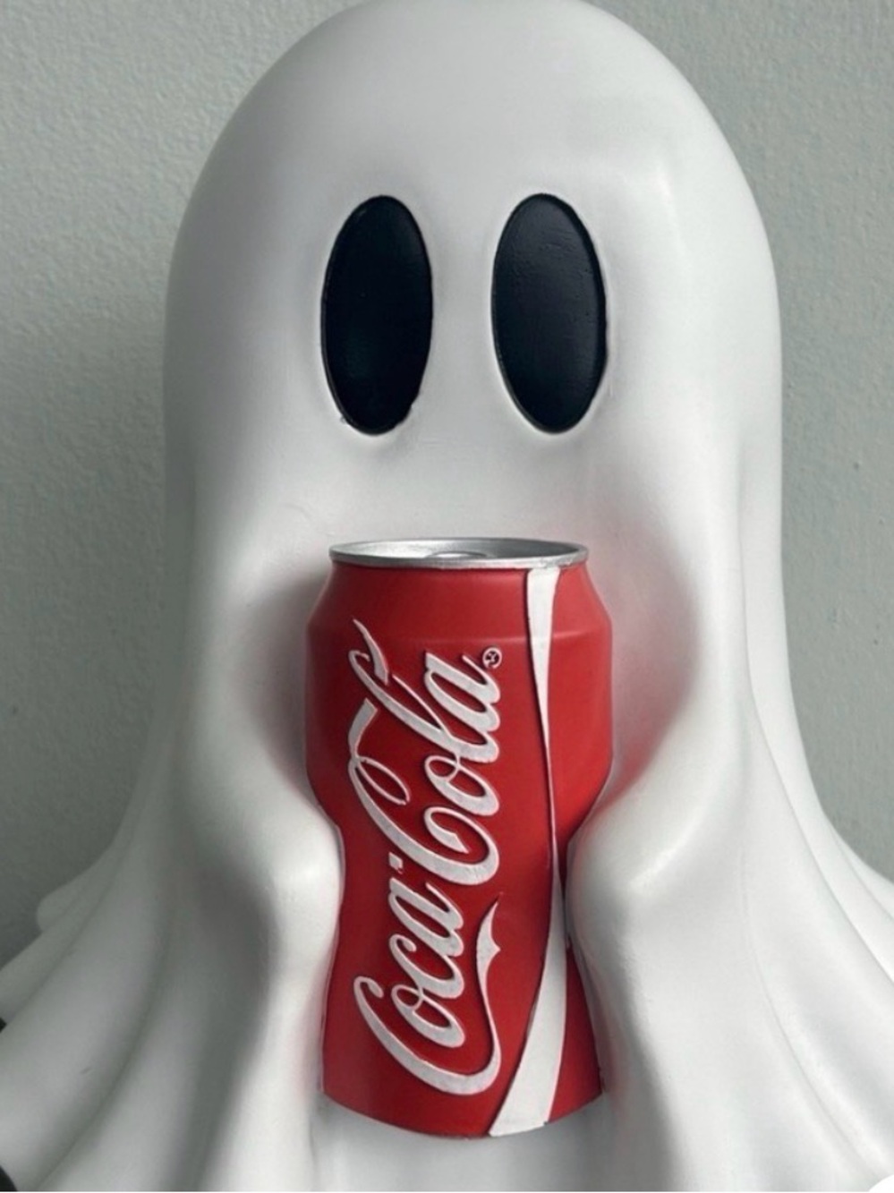 Coca-Cola Red and White Can Held by White Ghost Figurine